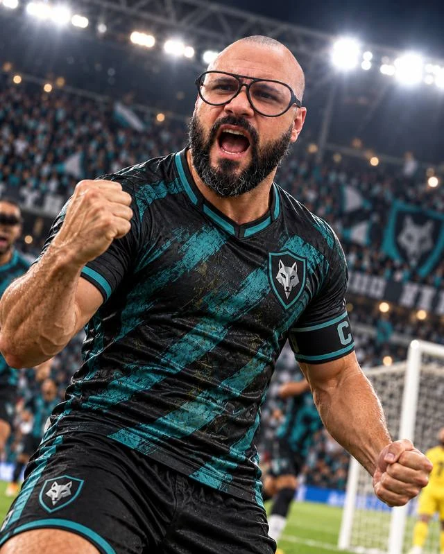 Vejota com uniforme de futebol comemorando em um estádio